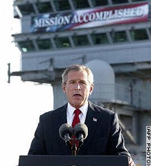 President Bush addresses the nation from aboard the USS Abraham Lincoln on May 1 with the banner in the background.