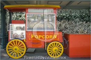 Picture of A red popcorn stand, next to a drive in