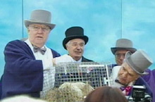 Wiarton Willie's handlers consult with the rodent seer before announcement.