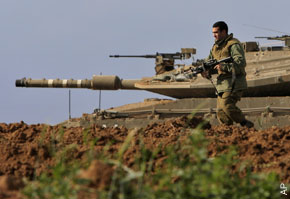 TENSE WAIT: An Israeli soldier patrols the Gaza border yesterday as leaders guess at what a President Obama will do.