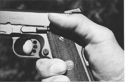 Traditional grasp of the .45 autoloader. Thumb rests on manual safety, pad of index finger is in contact with trigger.