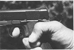 Author prefers this grasp: thumb curled down for more gripping strength, trigger finger inserted